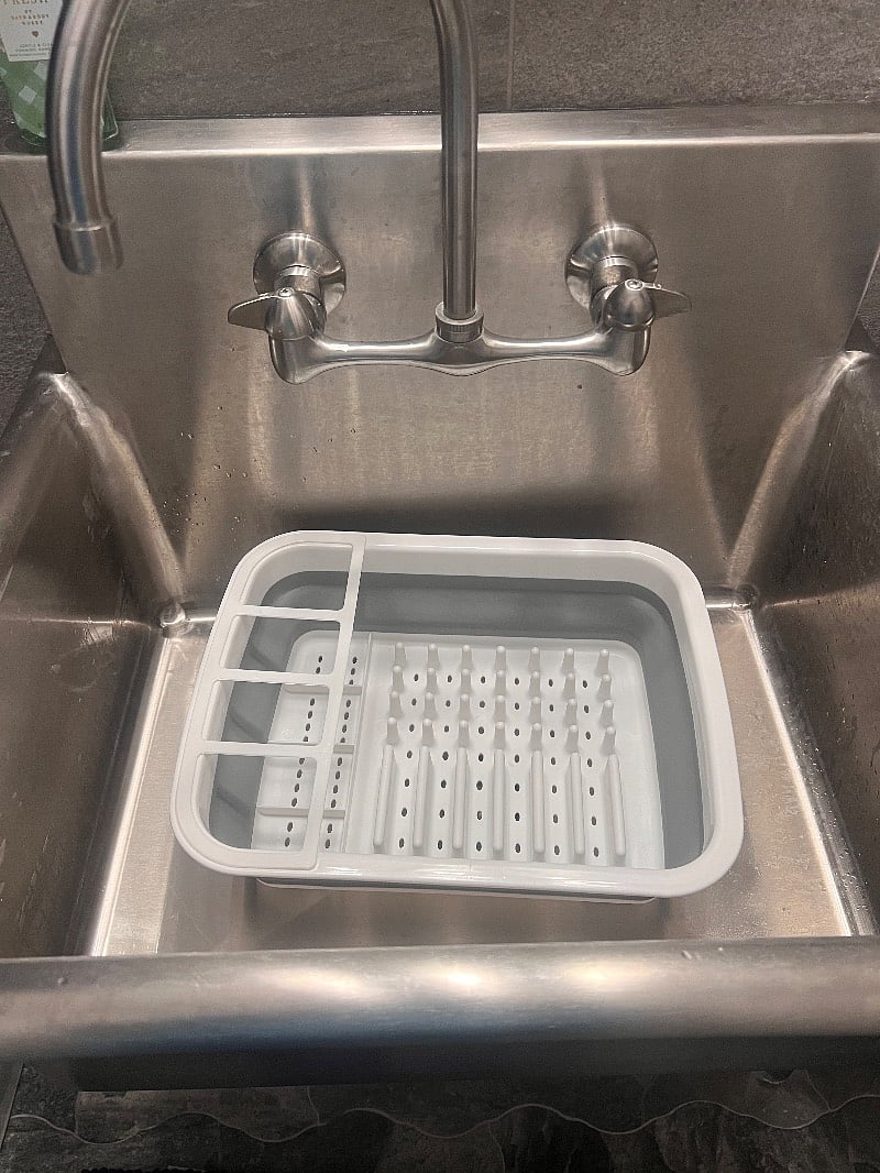 Large industrial sink in the bathroom for dishwashing.