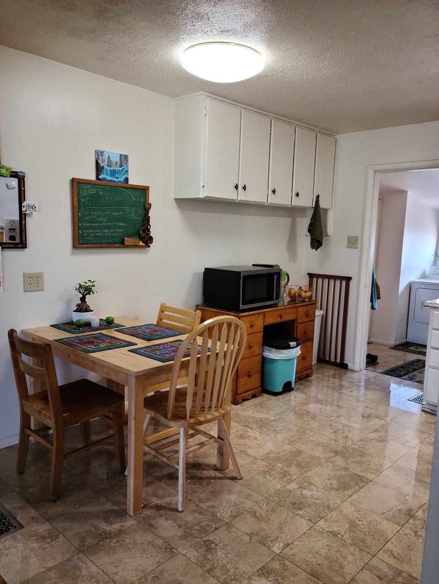 Kitchen eating area with new microwave and single cup coffee maker.