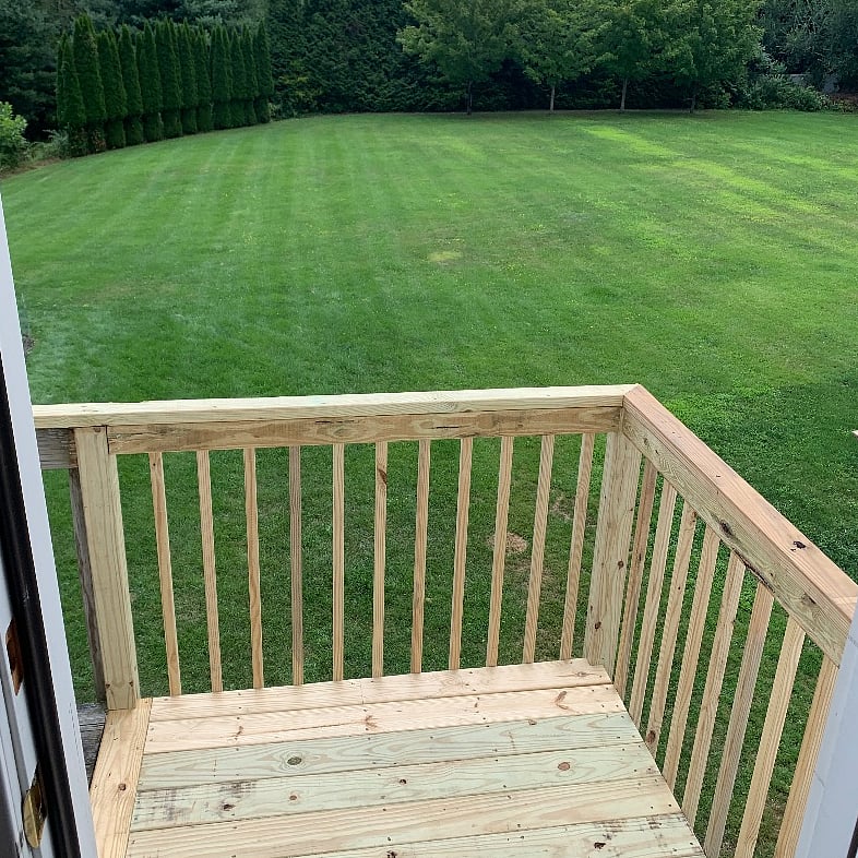 Step out of the kitchen door to the apartments own balcony deck overlooking the beautiful yard.