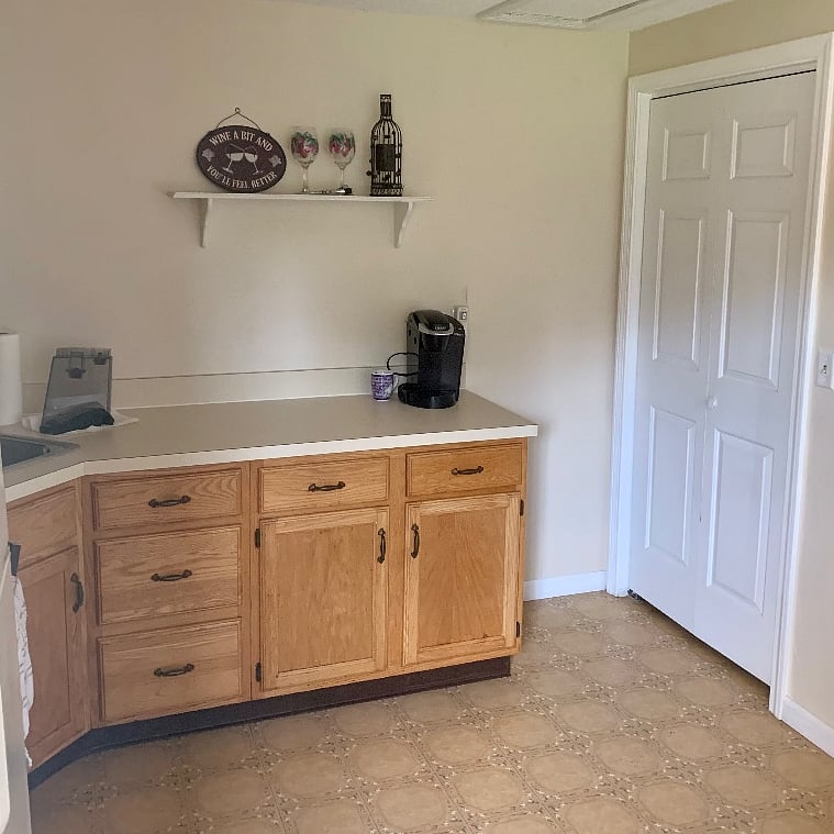 A large pantry closet in the kitchen and everything you need to make coffee. Not pictured is the table with two chairs.
