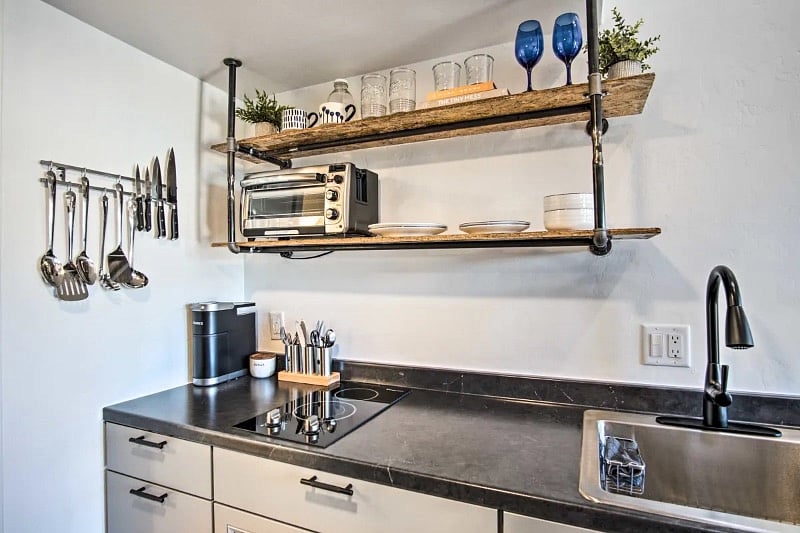 The kitchen features a full toaster oven that offers the ability to bake a pizza, toast bread or bake something delicious. A microwave, a glass stove-top with 2-burners, a Keurig, a large sink and all the standard kitchen supplies you will need. 