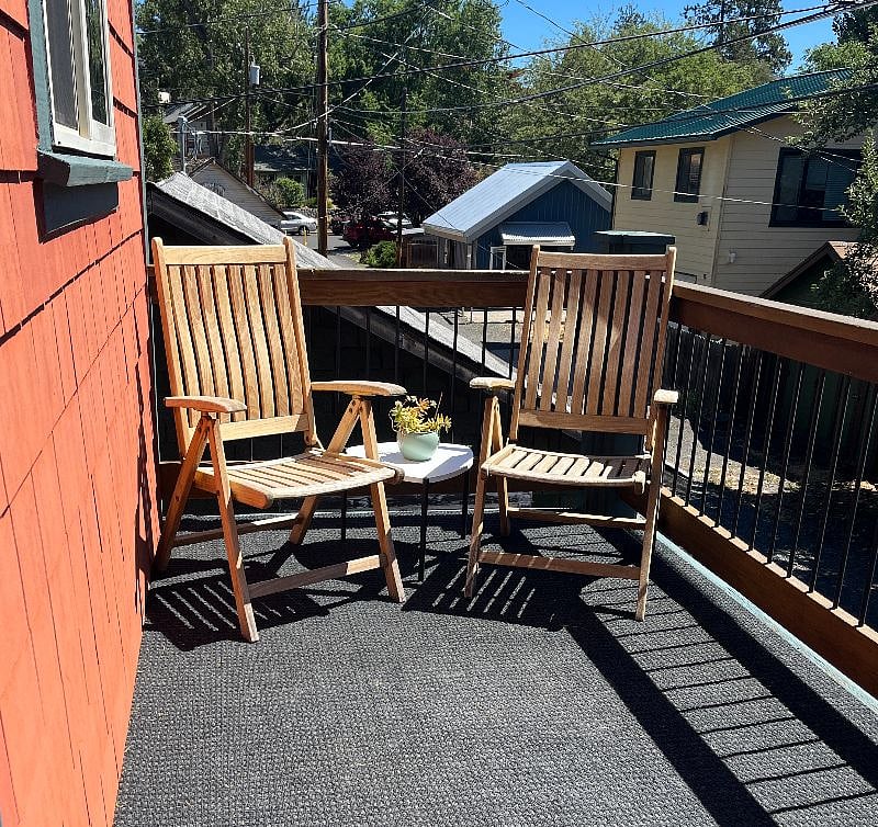 Large sunny deck with chairs and tables