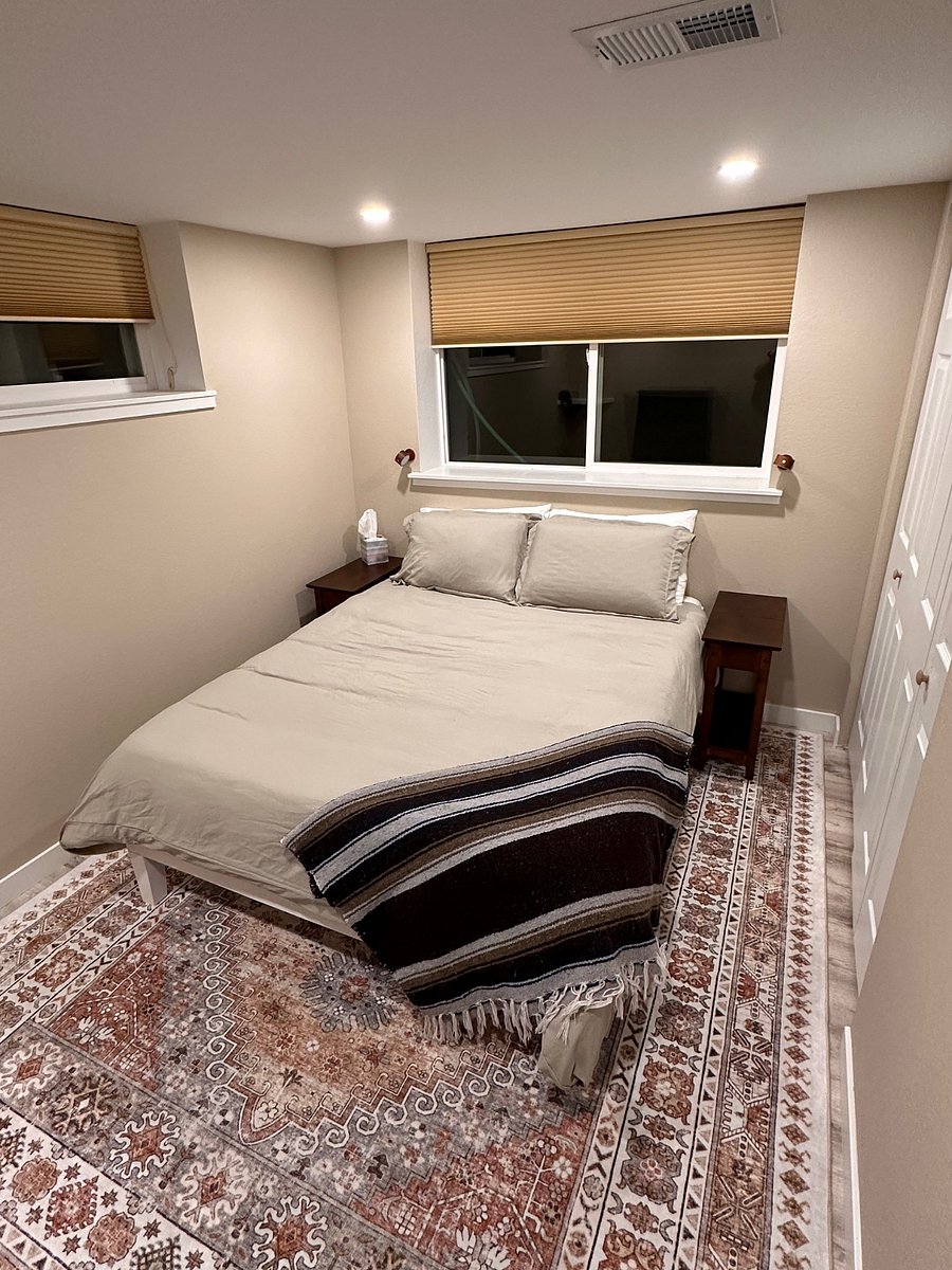 Main bedroom with plush memory foam mattress, bamboo sheeting, microfiber duvet cover, and cool wall-mounted dimmable LED lights for evening reading.