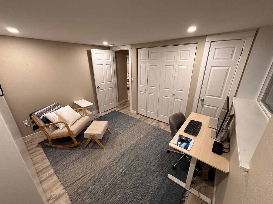 Office/2nd bedroom w/ sit-stand desk, 27" 4K Dell Monitor, Dell docking station, bluetooth keyboard and mouse, murphy bed (in folded up position) and rocking/reading chair with nightstand - The closet is through the double doors in the middle.