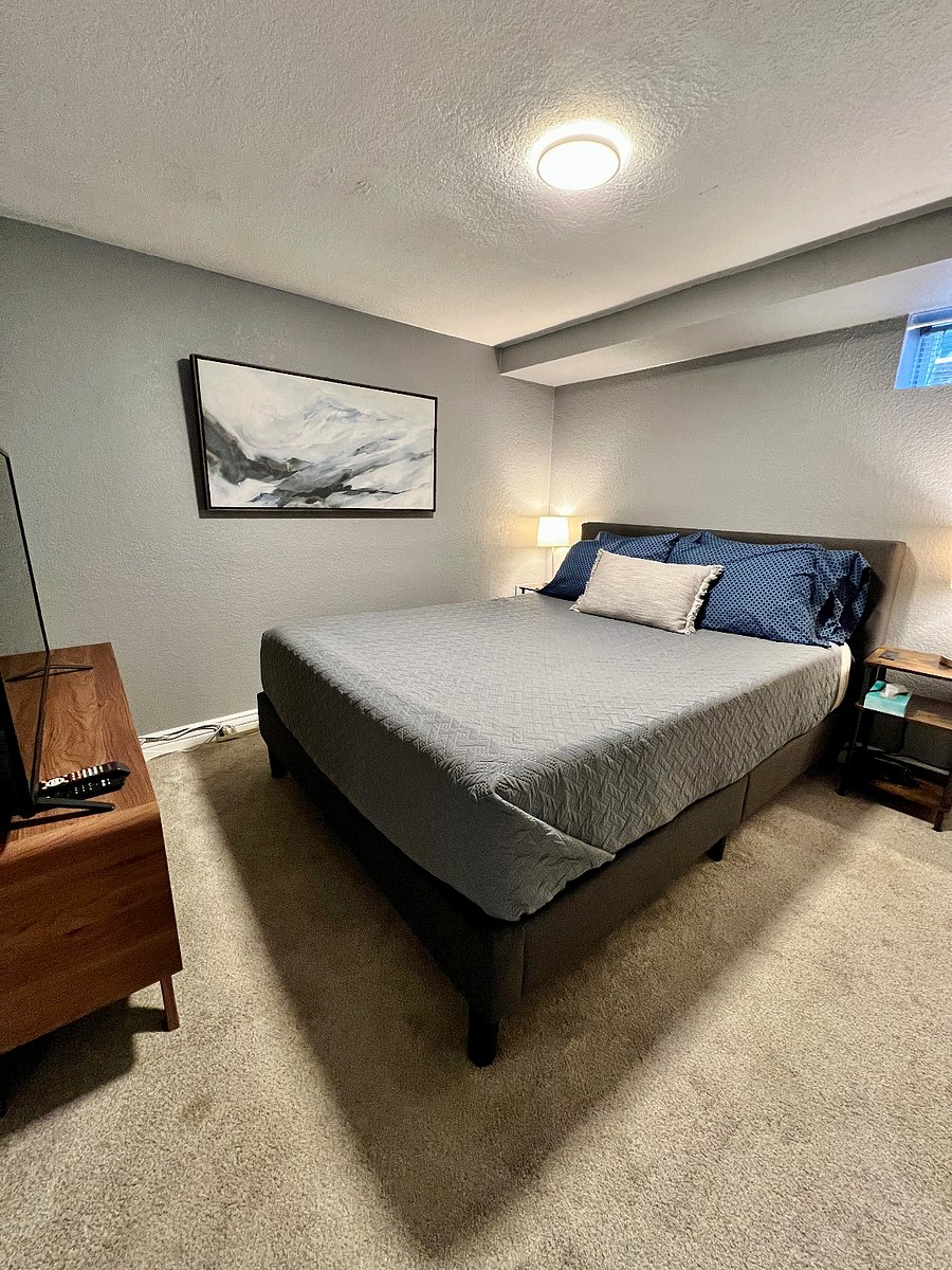 Comfortable Queen sized bed, 50-inch TV, and blackout curtains