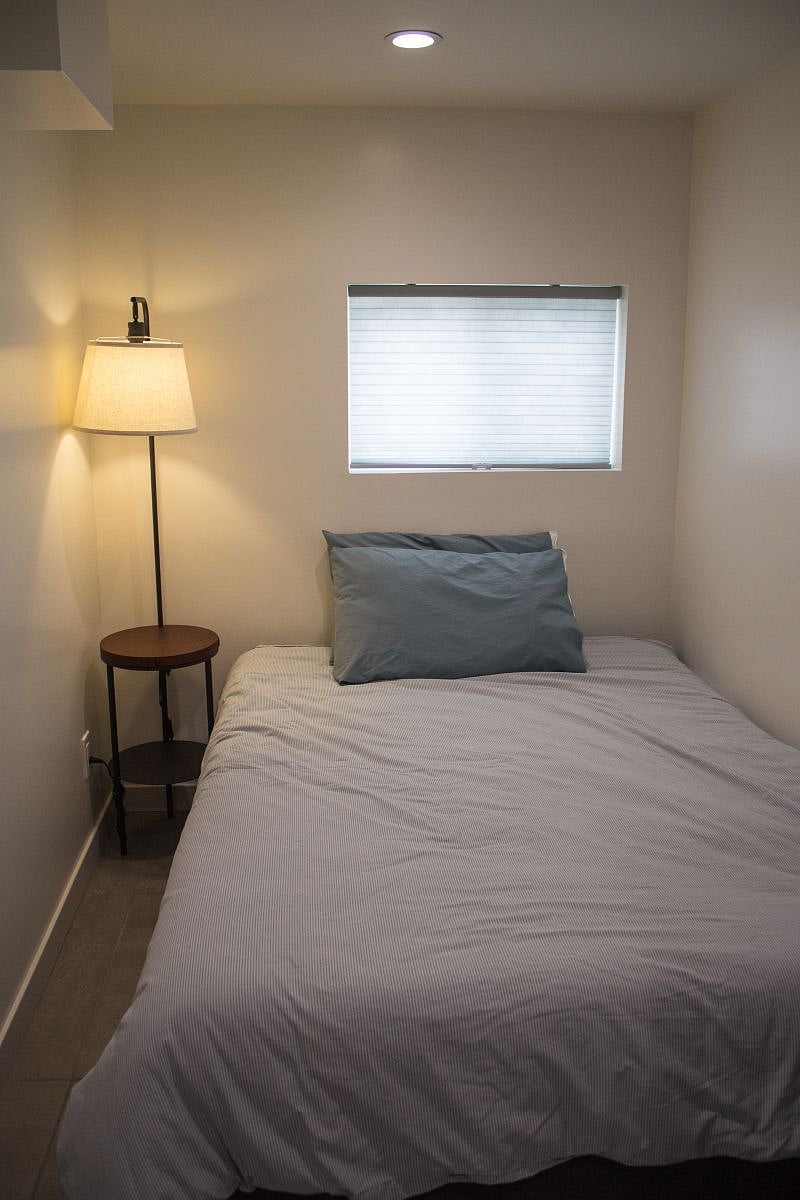 Newly designed bedroom with double sized memory foam mattress and charging station for phone/tablet.