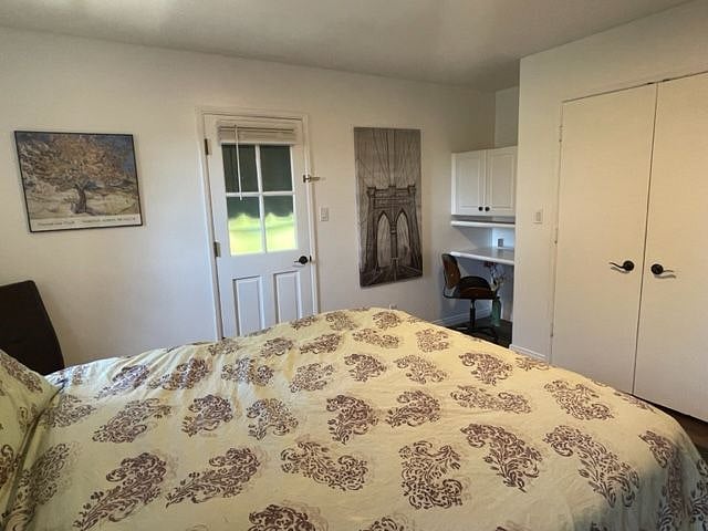 Large closet with drawers. Built in desk/work station with overhead storage.