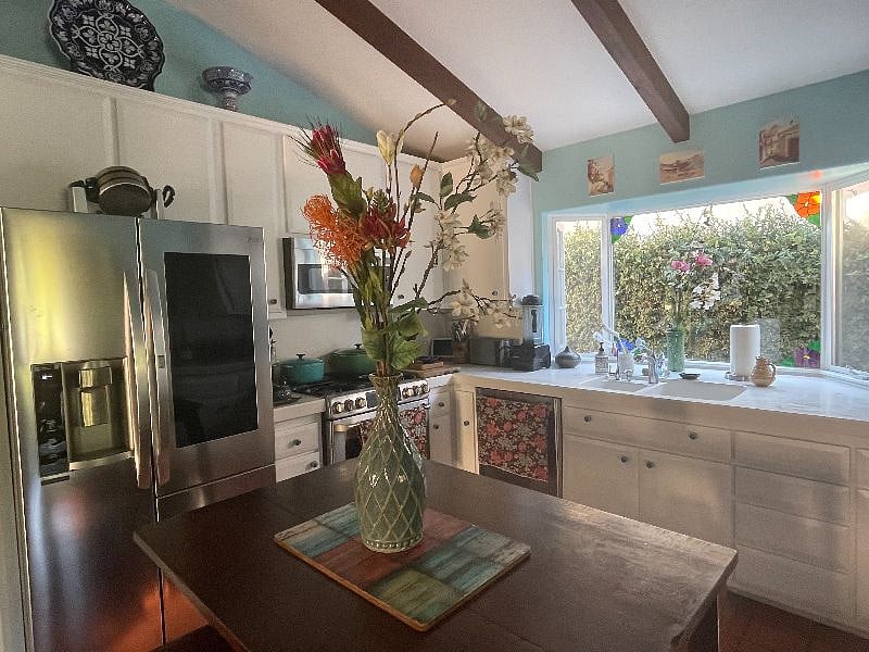 Fully equipped kitchen with gas stove and electric oven.