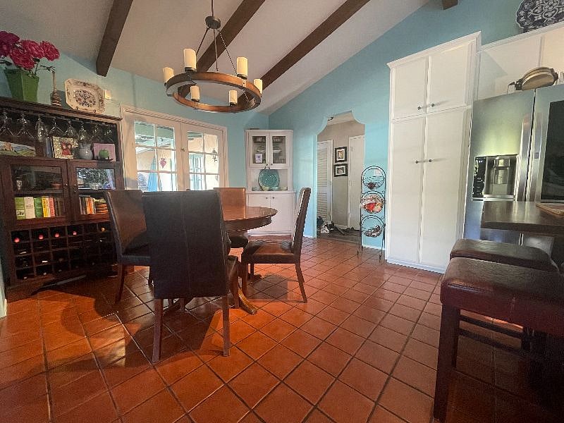 Easy access to lovely outdoor courtyard with built-in barbecue, fountain, dining table and sitting area.