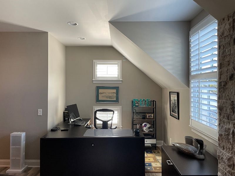 large desk face tv in den, a person 6 feet tall can easily walk to the right of the desk even with the angled ceiling.