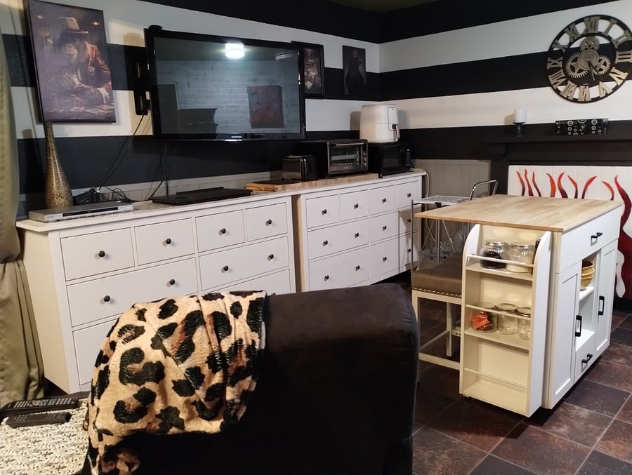 kitchen island and 2 large dressers and mounted TV