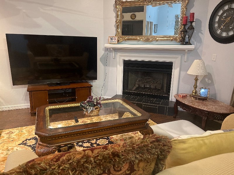 Living room with fireplace and smart 75 inch television