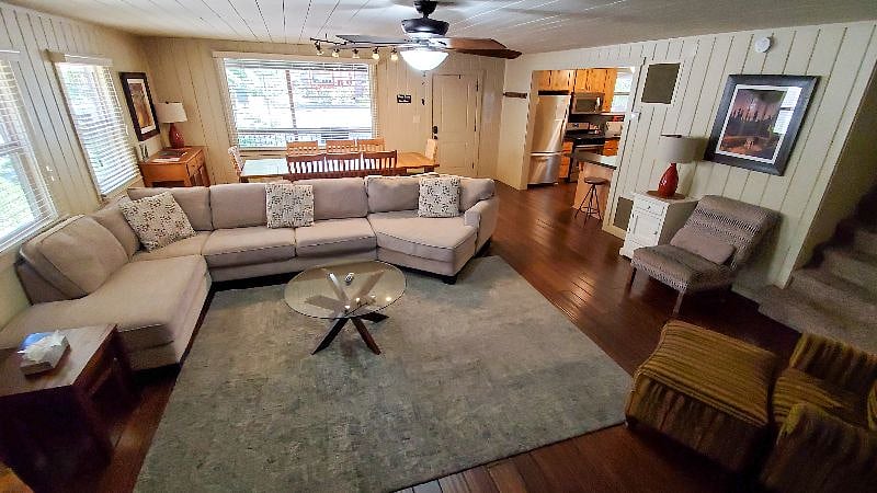 Downstairs Great room w/ house entrance, dining, kitchen, laundry, and bathroom. Large Roku TV, coffee table, ceiling fan
