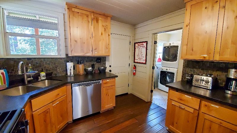 The kitchen has a gas stove, dishwasher, drip coffee maker, refrigerator, toaster, pots, pans, dishes, and more. The laundry is connected to the kitchen.