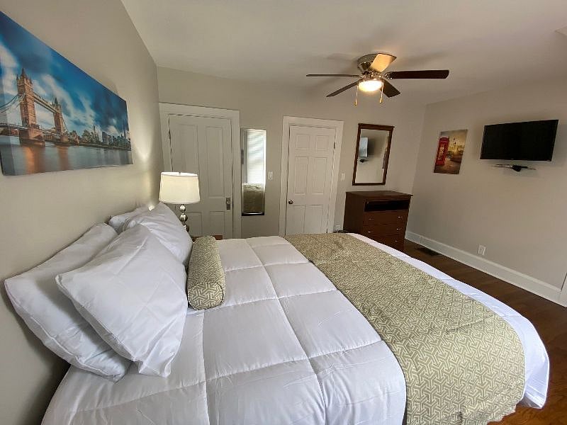 Bedroom 1 with Ultimate Sleep Experience. Double Plush Queen Beds with Extra Lumbar Support, Crisp New Bedding and Comfort Sleep Pillows.