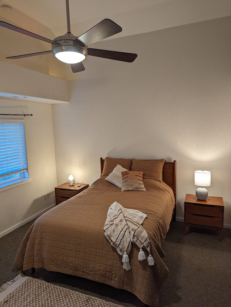 This bed is in the "loft" space, keep in mind that it is open to the rest of the house. The downstairs bedroom has 4 walls, but this space is bigger and more like a master bedroom.