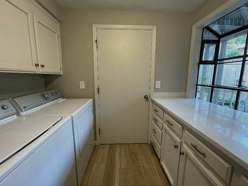 Laundry room with full-sized washer & dryer, garden window, and large utility sink.