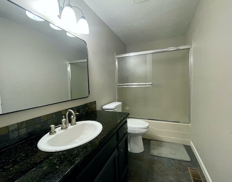 Upstairs full bathroom located in hall between Bedrooms 3 & 4.