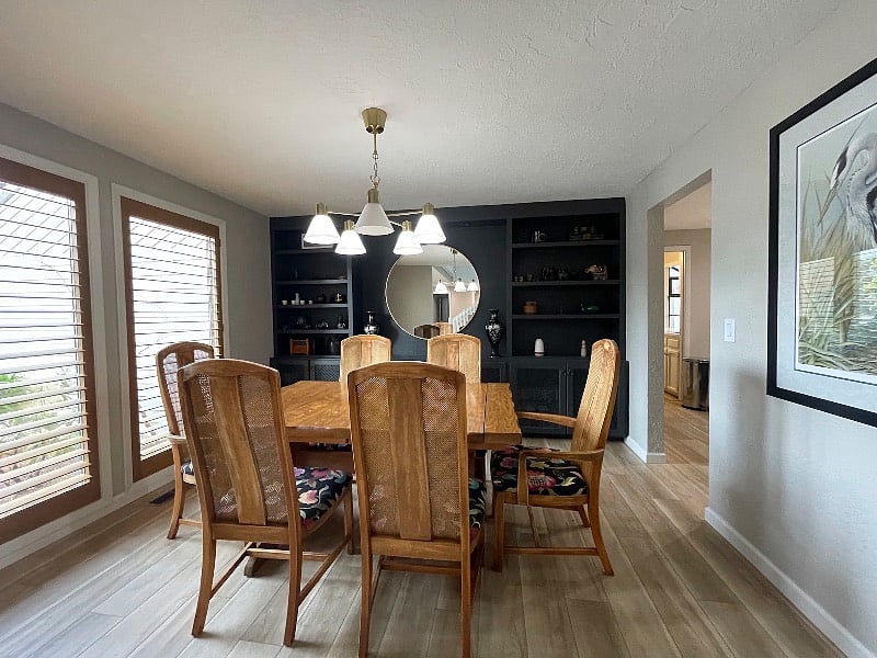 Dining room table with seating for 6 and large built-in display cabinet.