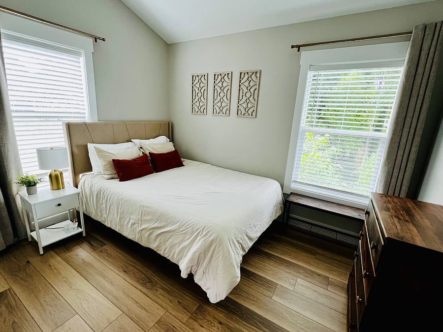 Bedroom 1 with a queen size bed and a dresser