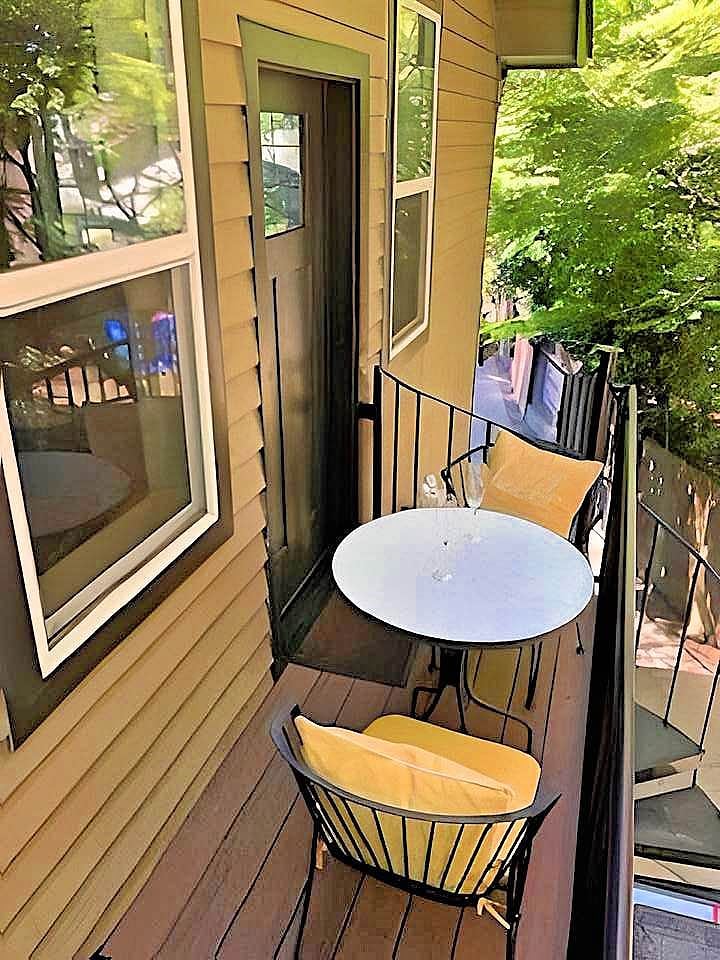 Private patio with bistro table and chairs amongst the tall fir growth trees.