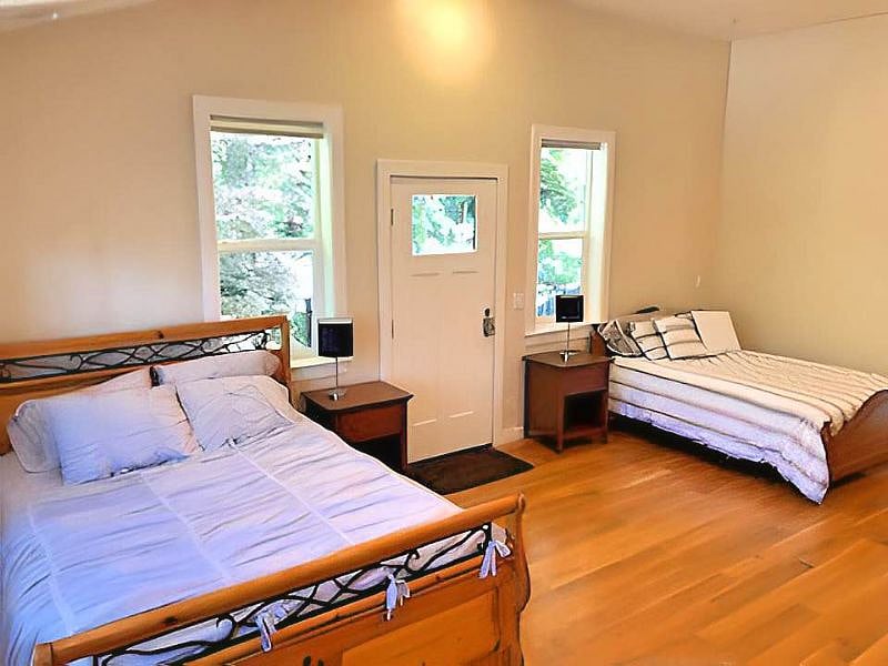 Large bedroom with vaulted ceilings and three closets.
