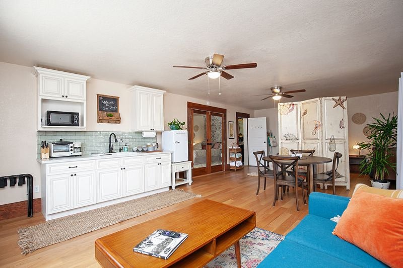 This is an outdated picture. The refrigerator is full-size now and there are two electric hotplates and an oven/toaster, as pictured above.