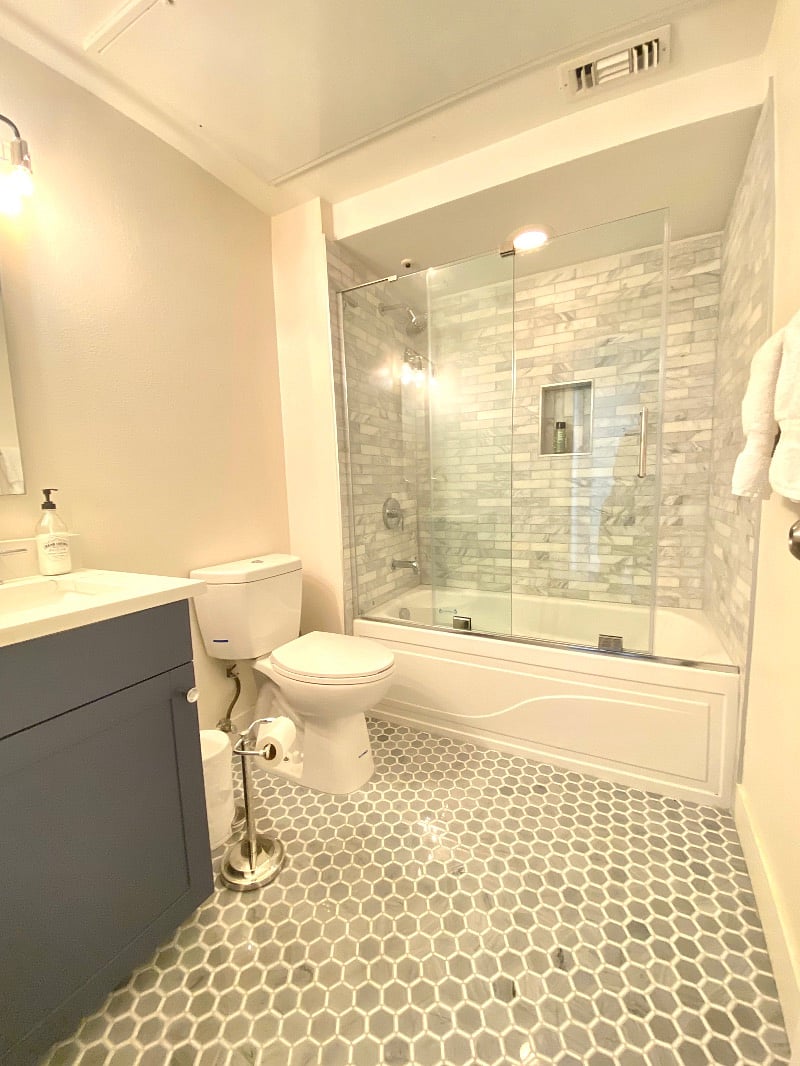 Second bathroom, also with TileBar marble tiles.