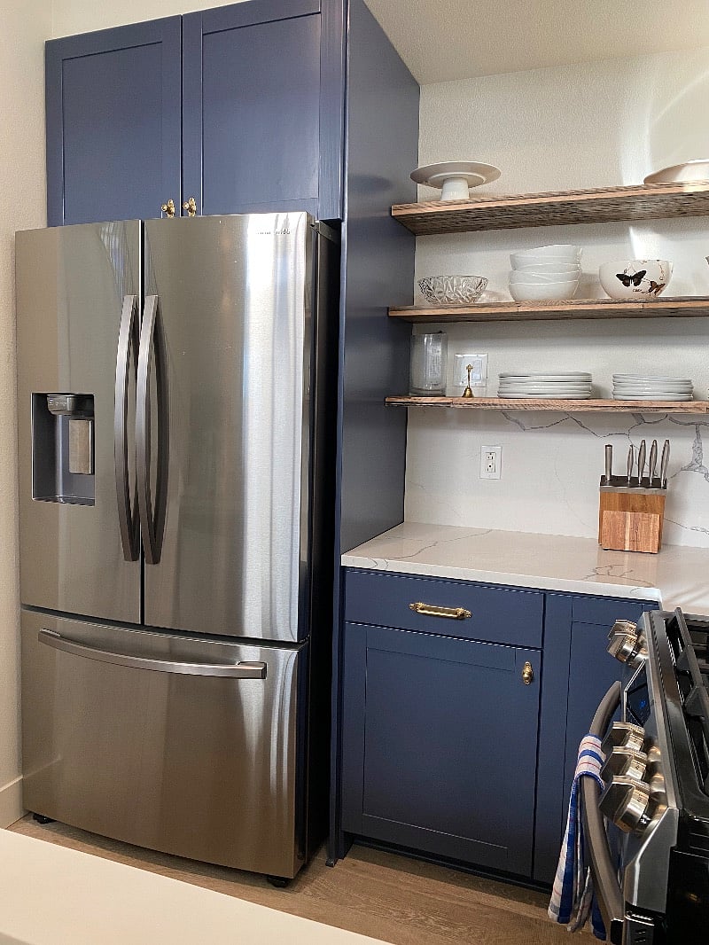 Counter depth stainless steel fridge. Reclaimed wood open shelves.