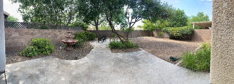 Backyard / Rear Patio; wood burning fire pit & 2 chairs are there.