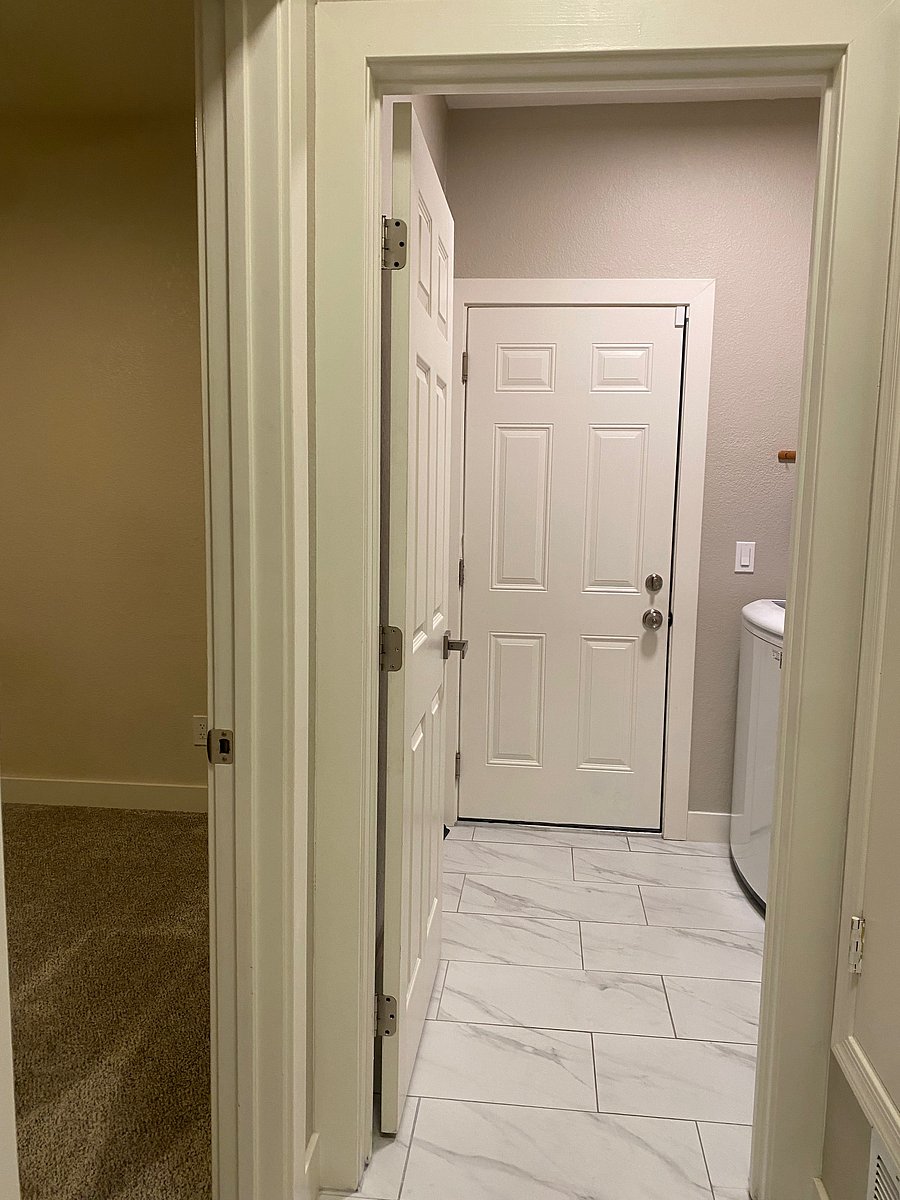Bedroom #3 on left; end of hallway looking into Laundry Room... closed door is to the Garage.