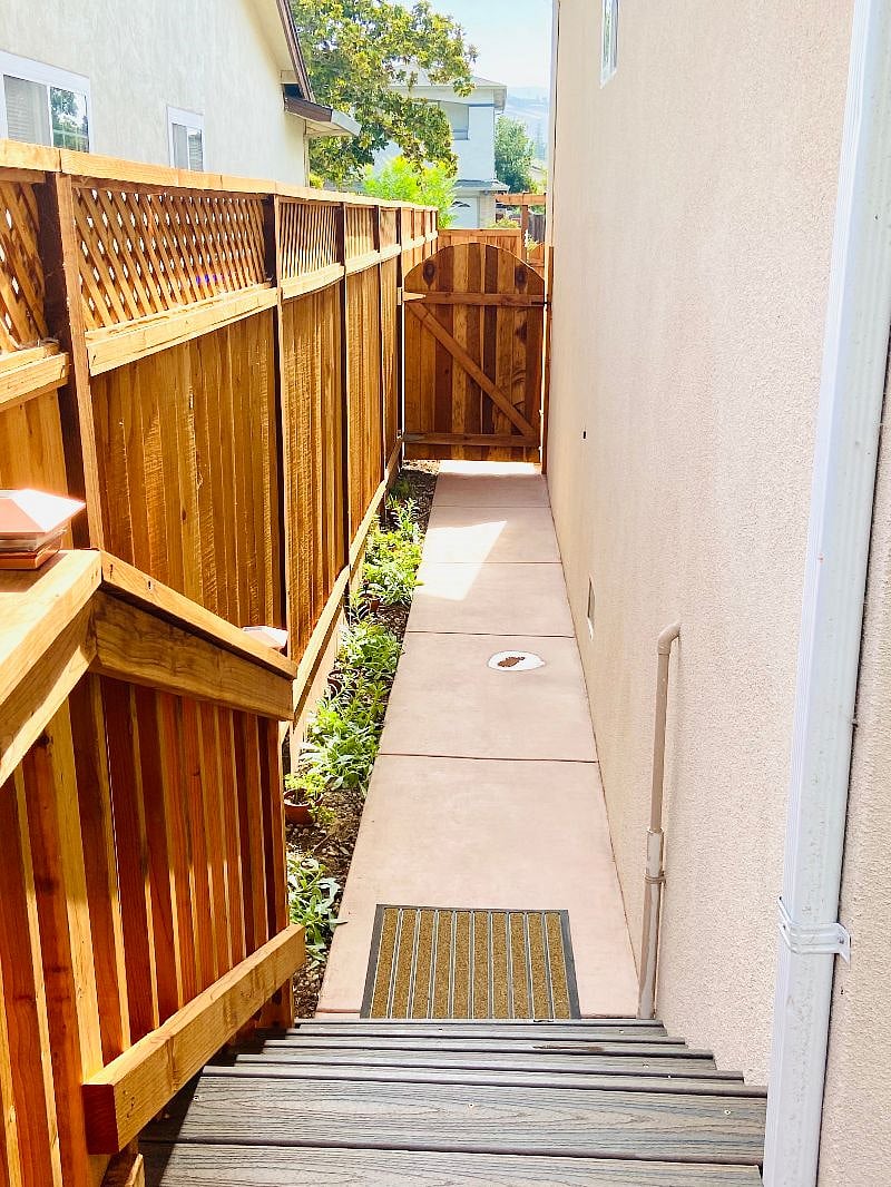 Pathway along the side leading to the deck, looking outside from the Guesthouse. The unit is completely fenced in for complete privacy. The unit entrance is through the french door in the back of the unit from the deck