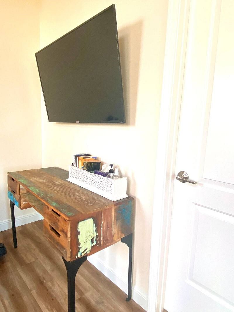 48inch mounted Smart TV with Netflix and Amazon video. Some books at the desk.