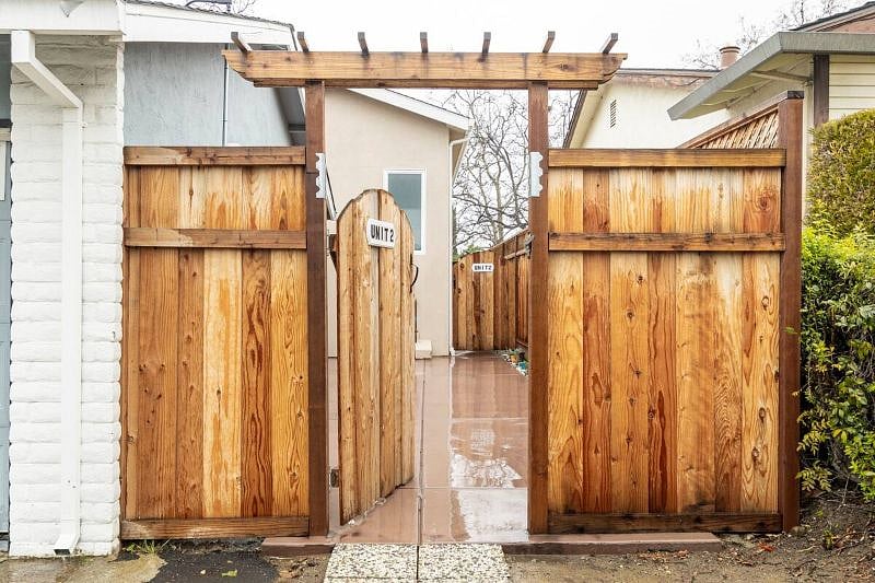 First Fence door entrance upfront from the street. Looking inside from the driveway