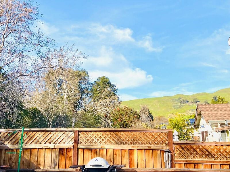 View of the Green hills on a rainy day in March from the outdoor dining chairs. The hills stay golden from Summer-Winter & turn lush green from Winter through Spring.