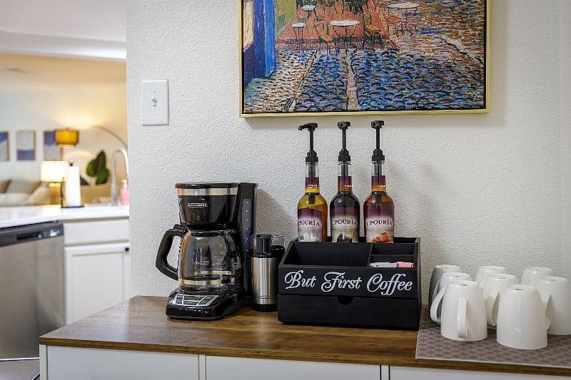 Coffee bar includes voffee, tea, kettle, coffee grinder and condiments