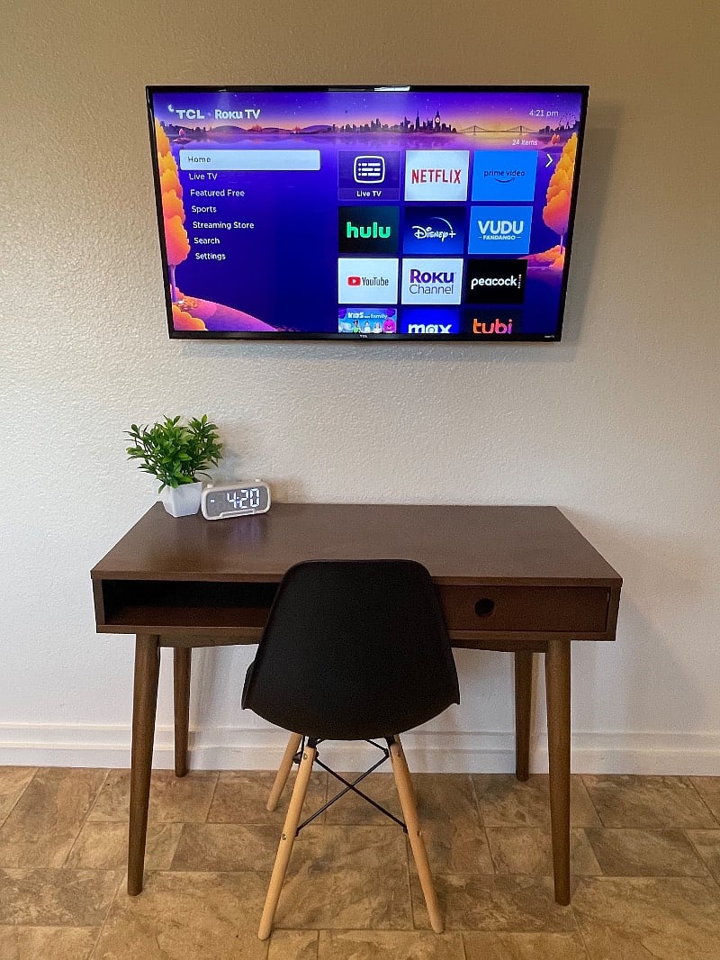 Roku Smart TV for guests to login to their desired streaming services. Desk for working professionals.