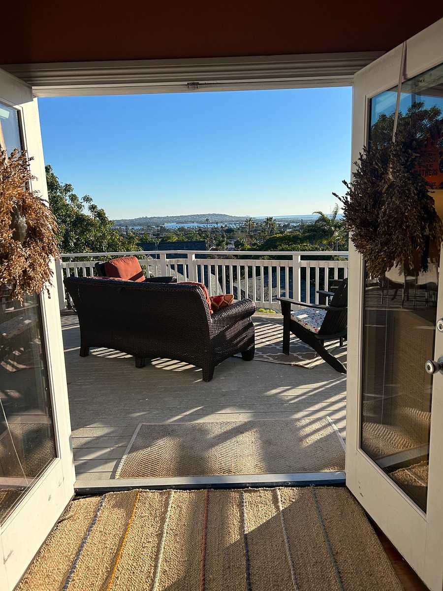 French doors open onto the large deck with ocean views