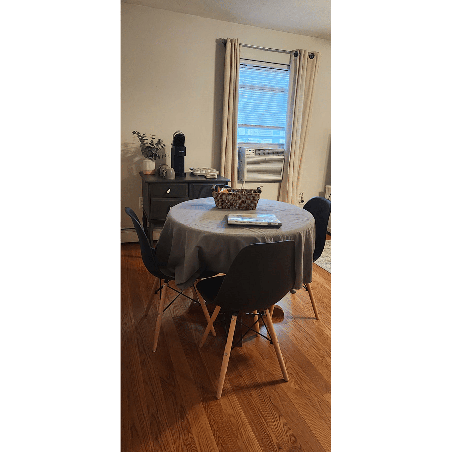 Living room with large Smart TV, dining area, and coffee bar