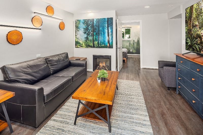 Living room - Includes front entrance which opens to a private patio.

- 75" Samsung Smart TV

- Electric fireplace

- Couch pulls out to make a full size bed