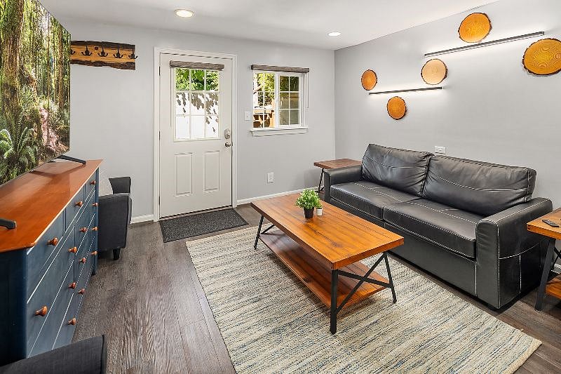 Living room - Includes front entrance which opens to a private patio.

- 75" Samsung Smart TV

- Electric fireplace

- Couch pulls out to make a full size bed