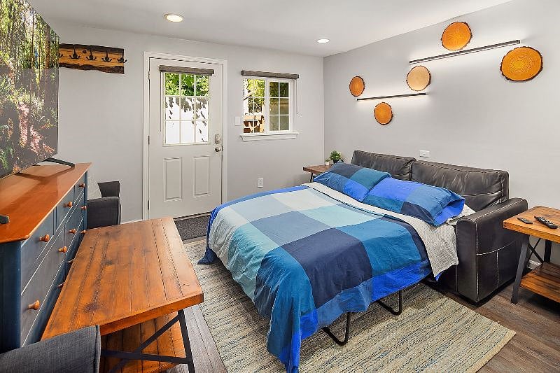 Living room - Includes front entrance which opens to a private patio.

- 75" Samsung Smart TV

- Electric fireplace

- Couch pulls out to make a full size bed