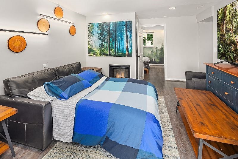 Living room - Includes front entrance which opens to a private patio.

- 75" Samsung Smart TV

- Electric fireplace

- Couch pulls out to make a full size bed