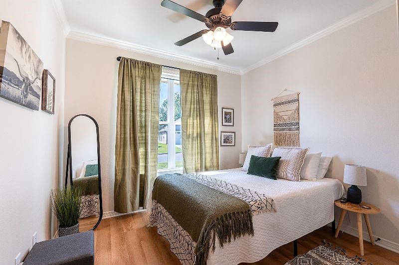 Modern front-of-house bedroom offering full size mirror, darkening shades,