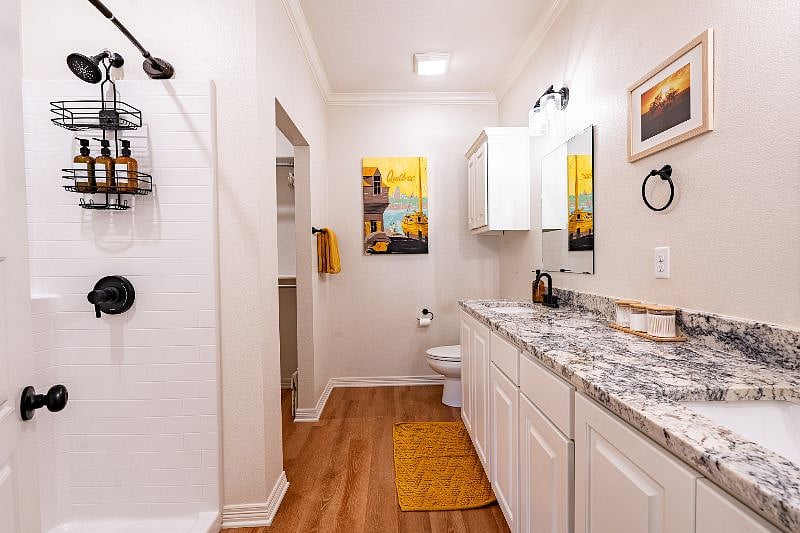 Double sinks, beauty swabs, and luxurious bath soaps provided. Photo shows entrance to master closet.