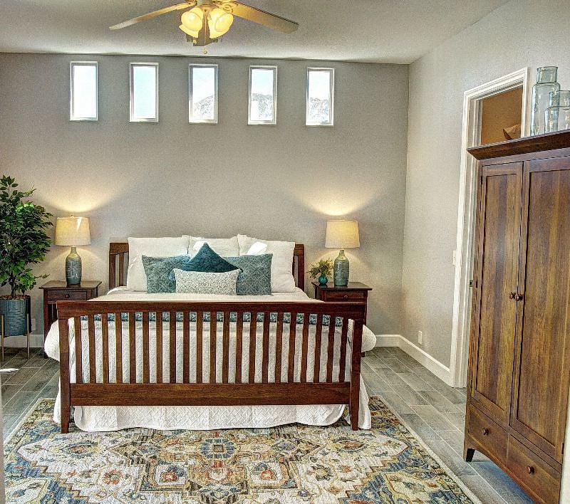 Spacious Primary bedroom with en suite, large walk-in closet and armoire