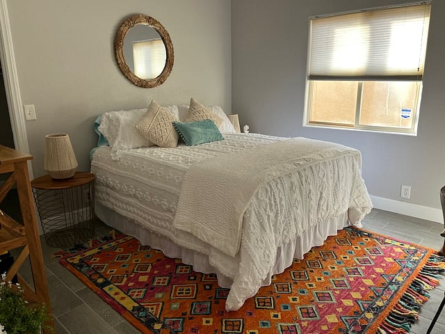 Cheery, bright queen bedroom with walk in closet