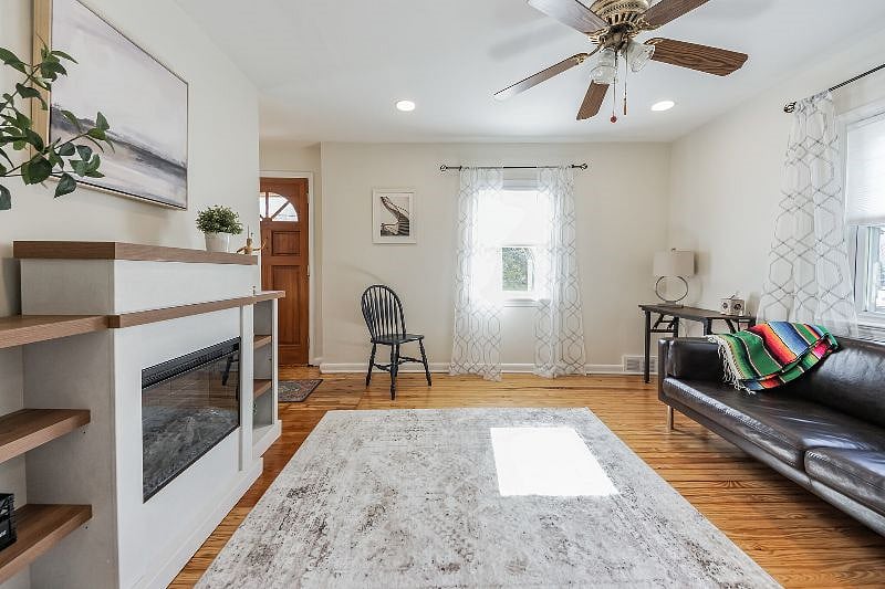 Office/reading area with electric fireplace, two windows