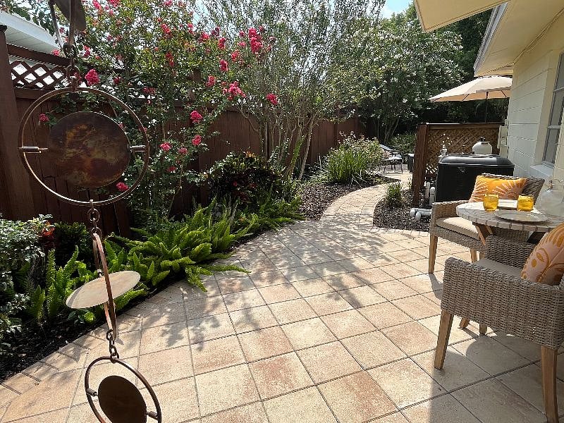 This landscaped path takes you out to the pool and the expansive backyard.