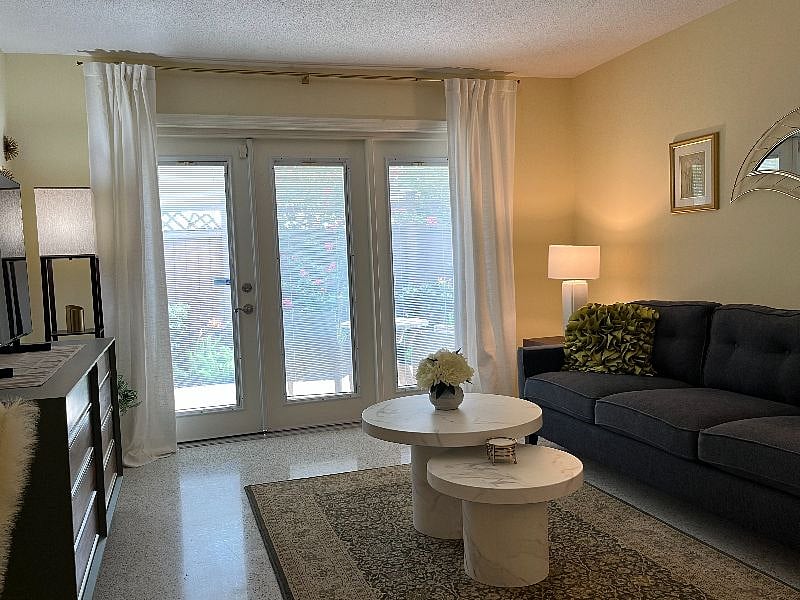 Outside this door is a charming patio filled with amazing landscaping and cute bistro set, perfect for morning coffee.